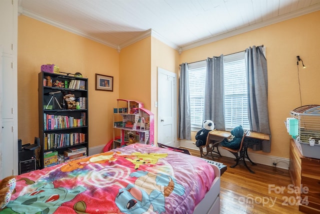 bedroom with crown molding and hardwood / wood-style flooring