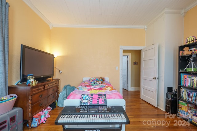 bedroom with hardwood / wood-style flooring and crown molding