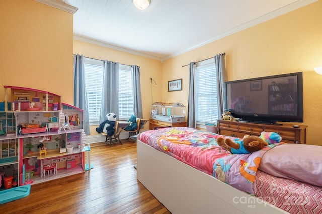 bedroom featuring wood-type flooring and crown molding