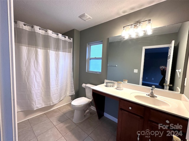 full bathroom with shower / bath combination with curtain, a textured ceiling, vanity, tile patterned flooring, and toilet