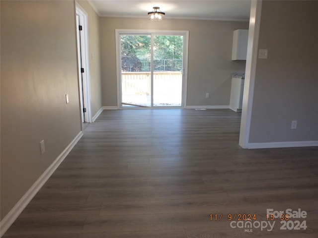 interior space featuring ornamental molding and dark hardwood / wood-style floors