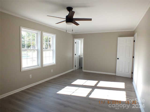 unfurnished room with ceiling fan, dark hardwood / wood-style floors, and ornamental molding