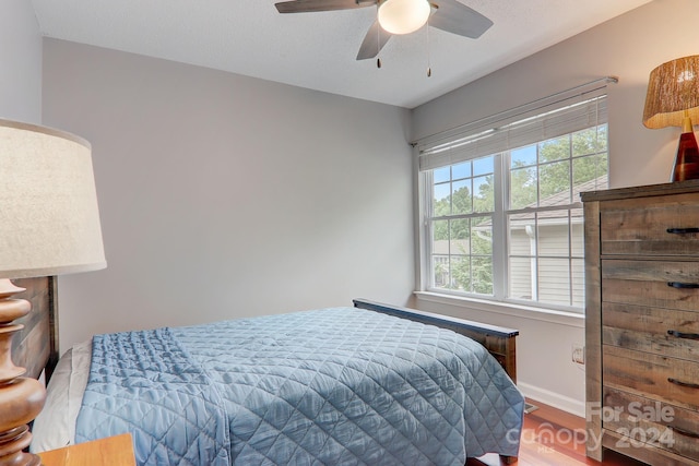 bedroom with hardwood / wood-style floors and ceiling fan