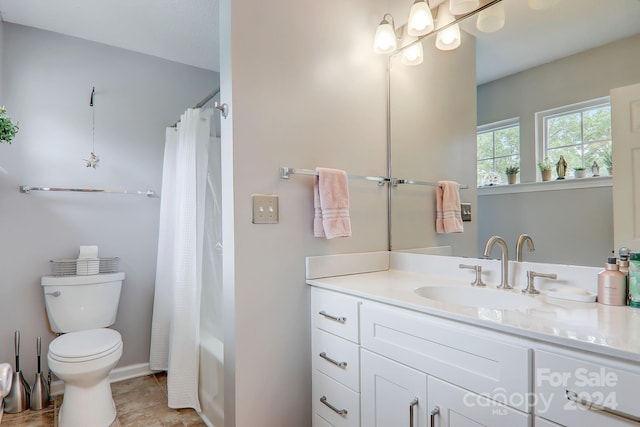 full bathroom featuring toilet, shower / tub combo with curtain, and vanity