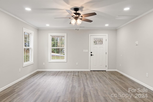 entryway featuring ornamental molding, hardwood / wood-style floors, and ceiling fan