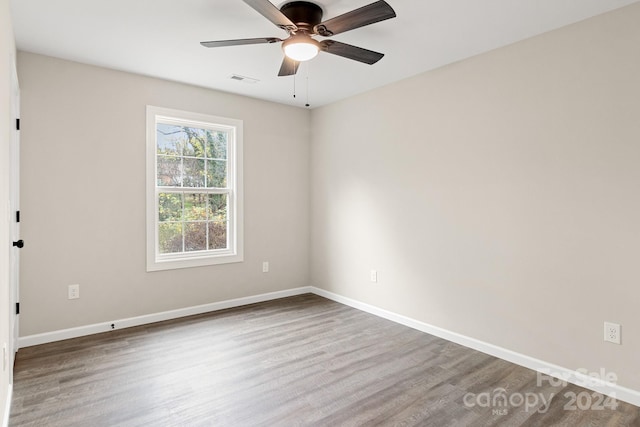 unfurnished room featuring hardwood / wood-style floors and ceiling fan