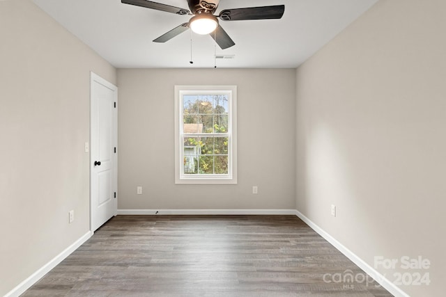 spare room with hardwood / wood-style floors and ceiling fan