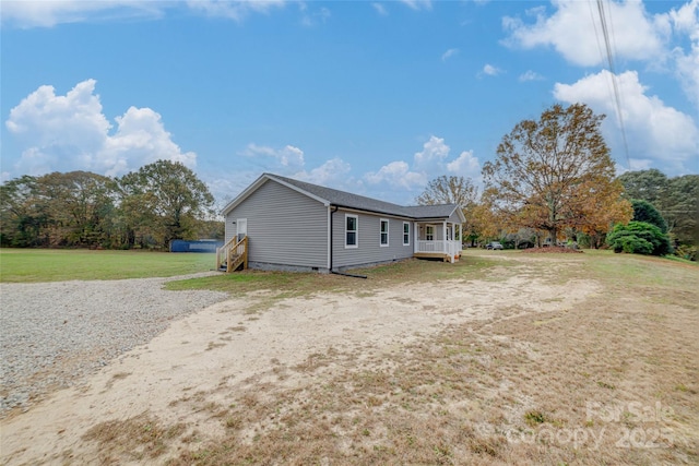 rear view of property featuring crawl space and a yard