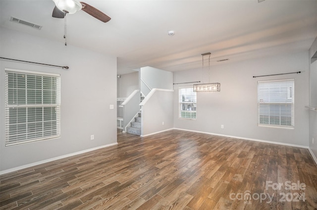 spare room featuring dark hardwood / wood-style flooring and ceiling fan