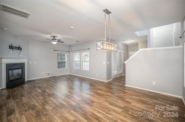 unfurnished living room with dark hardwood / wood-style floors and ceiling fan