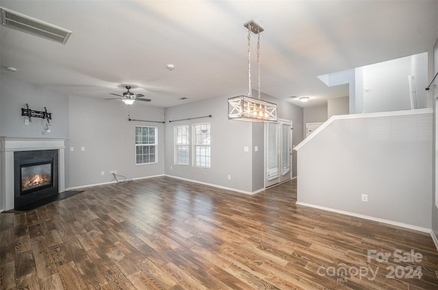 unfurnished living room with ceiling fan and dark hardwood / wood-style floors