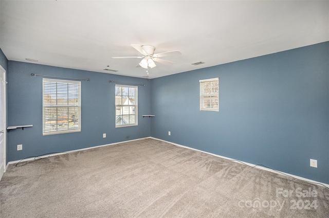 empty room featuring carpet flooring and ceiling fan