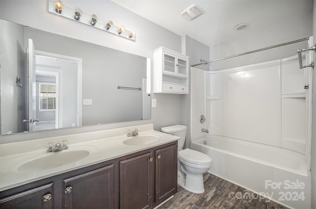 full bathroom with hardwood / wood-style floors, vanity, toilet, and shower / tub combination