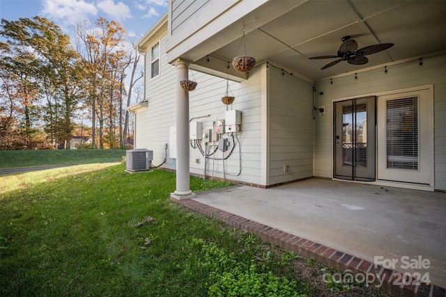 exterior space featuring central AC, ceiling fan, a patio area, and a lawn