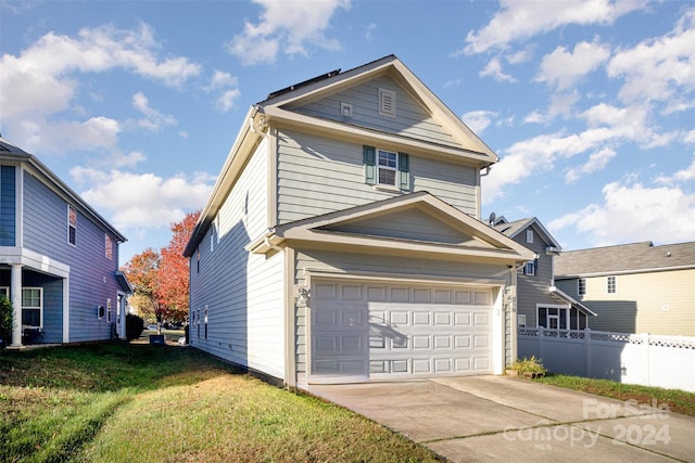 view of front property with a garage and a front lawn