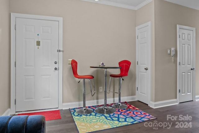 entryway featuring ornamental molding and dark wood-type flooring