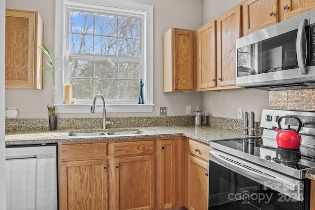 kitchen featuring a healthy amount of sunlight, sink, and stainless steel appliances