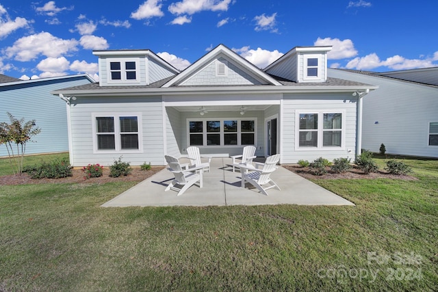 rear view of property with a patio, ceiling fan, and a lawn