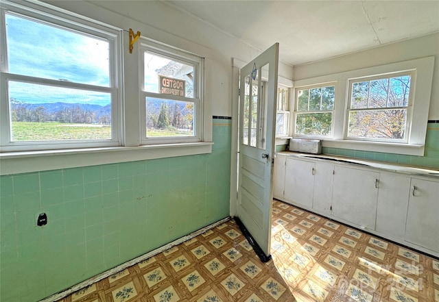 entryway with a mountain view and tile walls