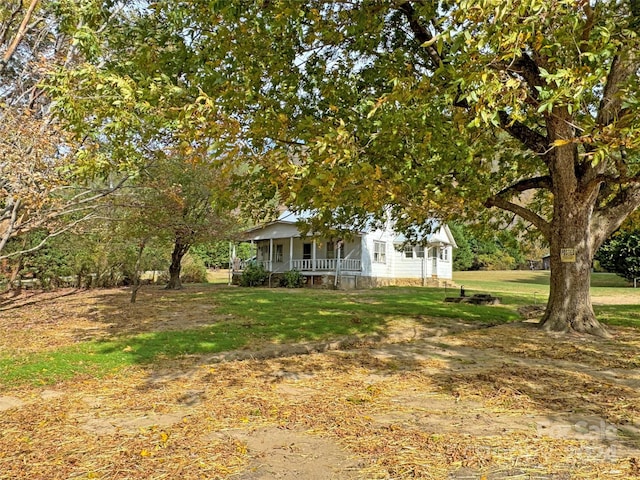 view of yard featuring covered porch