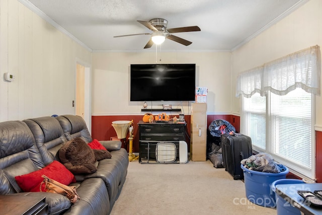 living room featuring light colored carpet, ceiling fan, and crown molding