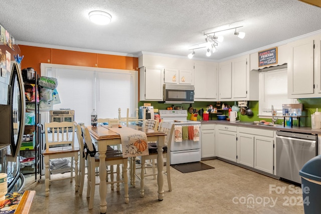 kitchen featuring stainless steel appliances, white cabinets, sink, and a textured ceiling