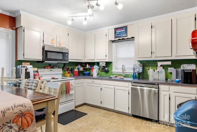 kitchen with stainless steel appliances, sink, a textured ceiling, crown molding, and white cabinets