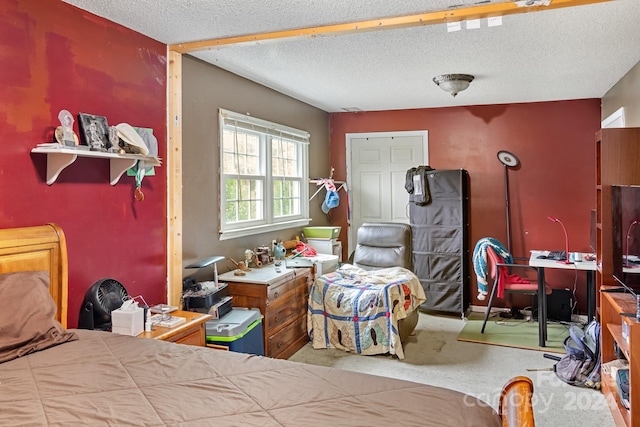 bedroom featuring carpet floors and a textured ceiling