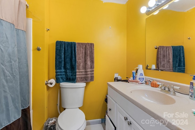 bathroom featuring walk in shower, vanity, and toilet