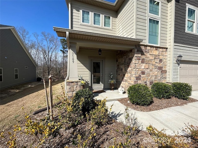 doorway to property with a garage