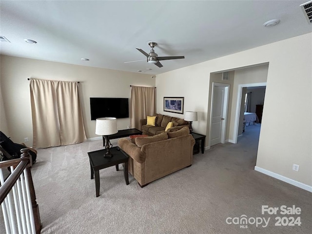 living room featuring carpet and ceiling fan