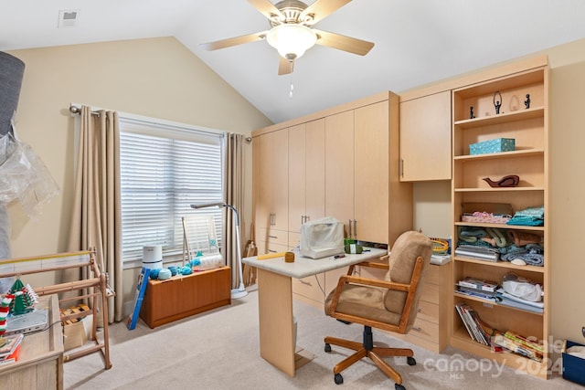 home office with light colored carpet, ceiling fan, and vaulted ceiling