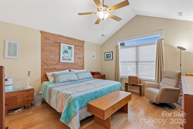 bedroom with lofted ceiling, ceiling fan, and light hardwood / wood-style flooring