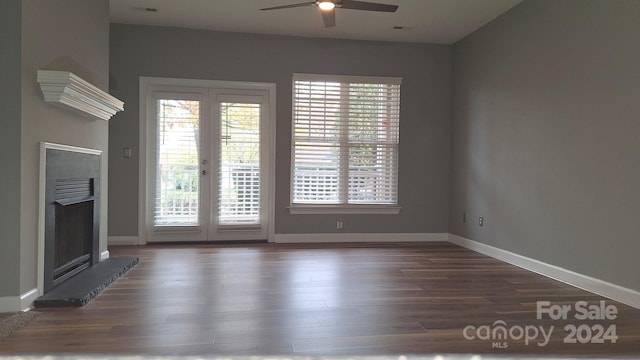 unfurnished living room featuring dark hardwood / wood-style floors, ceiling fan, and french doors