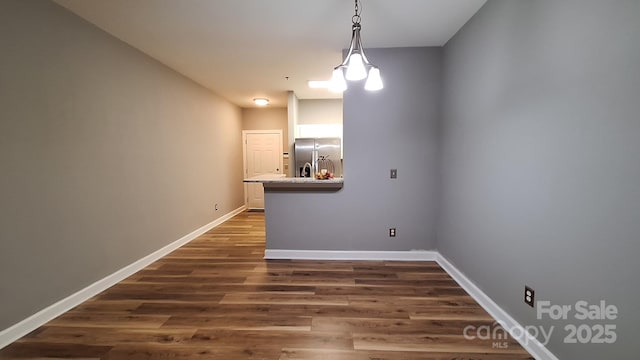 unfurnished dining area with dark wood-type flooring