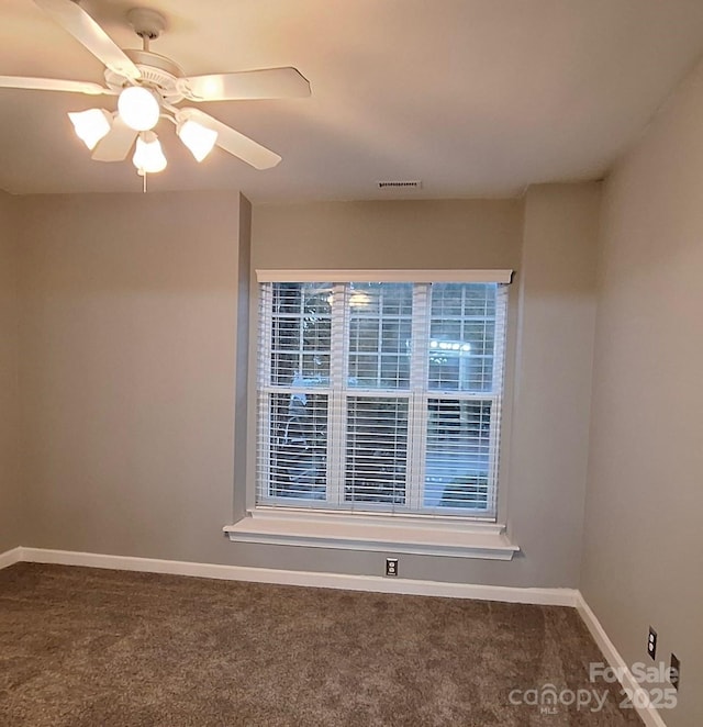 carpeted spare room with ceiling fan