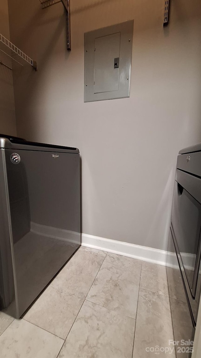 clothes washing area with washer / dryer and electric panel