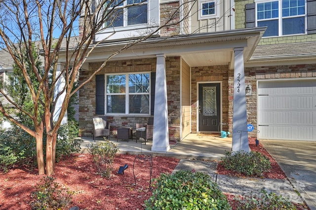 entrance to property featuring a porch and a garage