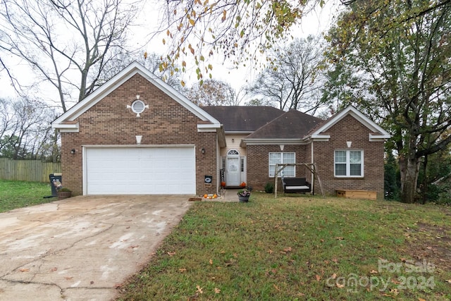 view of front of house featuring a front yard and a garage