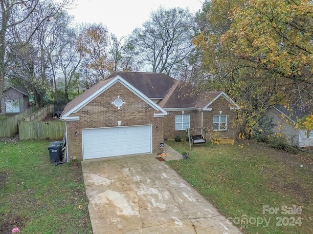 view of front of house featuring a garage and a front lawn