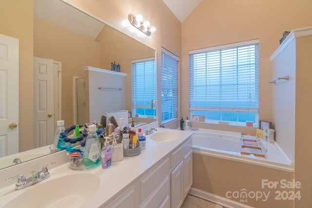 bathroom with vanity, lofted ceiling, and independent shower and bath