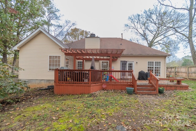 back of property featuring a pergola and a deck