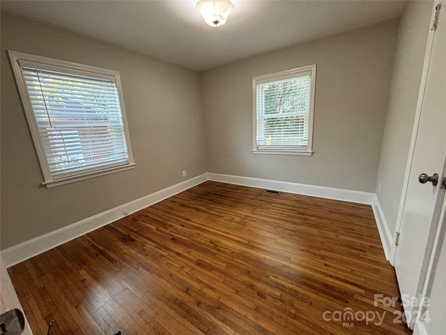 empty room featuring dark wood-type flooring