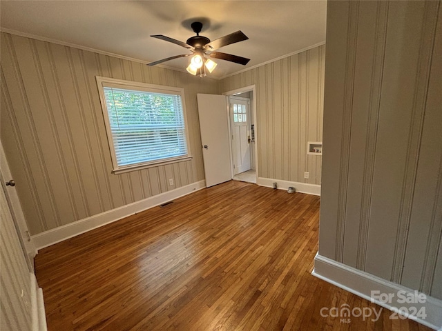 unfurnished room with hardwood / wood-style floors, ceiling fan, and ornamental molding