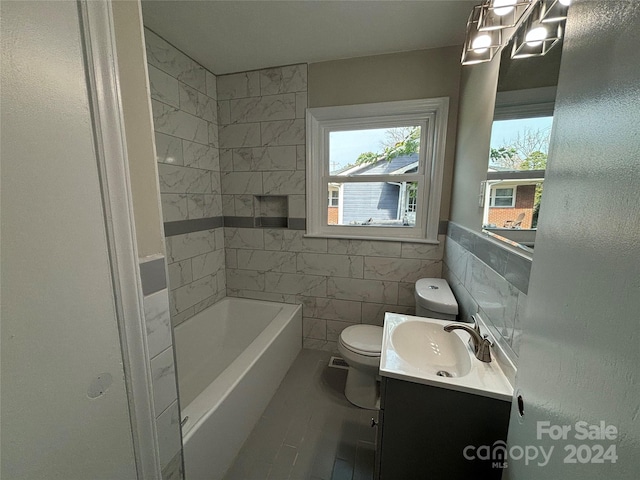 bathroom with vanity, a tub to relax in, toilet, and tile walls