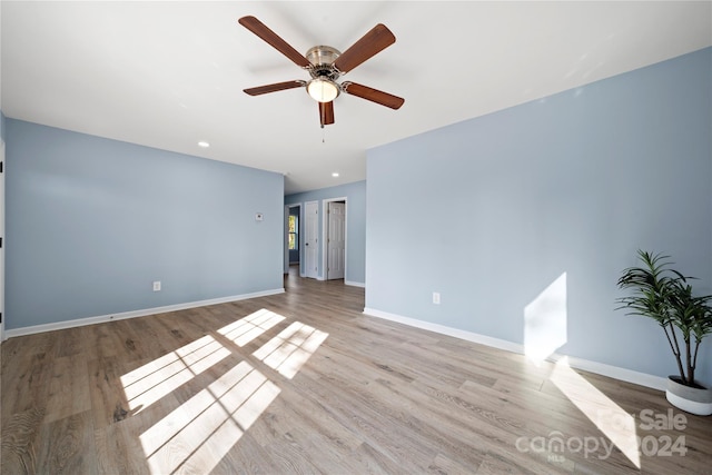 unfurnished room with light wood-type flooring and ceiling fan