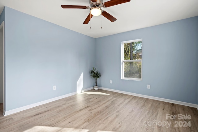 spare room featuring ceiling fan and light hardwood / wood-style flooring