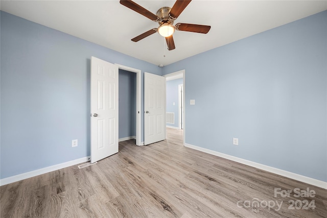 unfurnished bedroom featuring light hardwood / wood-style flooring and ceiling fan