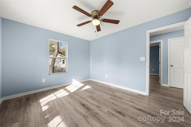 spare room with wood-type flooring and ceiling fan