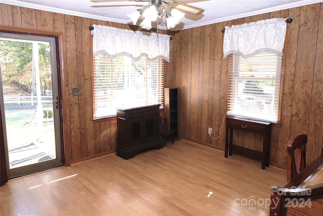 interior space featuring plenty of natural light, light wood-type flooring, and ornamental molding